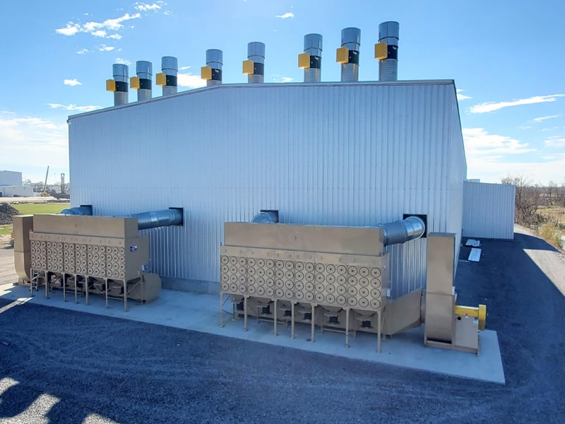 Two Large Industrial Dust Collectors Outside Facility - ABS Blast